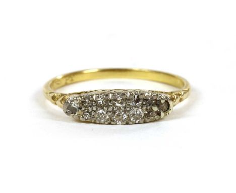 A gold boat shaped diamond ring, with two rows eight cut diamonds, with a single eight cut diamond at each end, all grain set