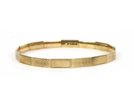 An Art Deco 9ct gold bangle, by Henry Griffith &amp; Sons, with alternating plain polished and engine turned sections, Cheste