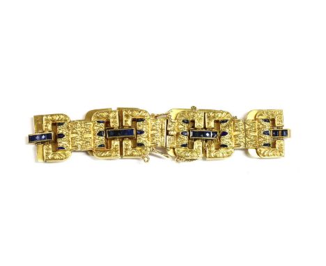 A Continental gold sapphire and enamel bracelet, c.1930 , with geometric buckle style links, decorated with repoussé scrollwo