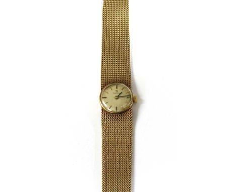 A ladies' 9ct gold Omega mechanical bracelet watch, c.1960, 20mm diameter, with a silvered dial, black and gilt baton hour ma