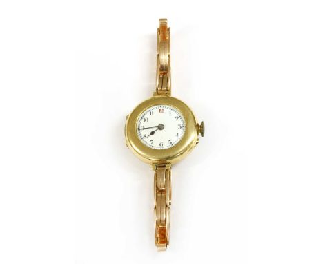 A ladies' 18ct gold pin set mechanical bracelet watch, 27mm diameter with a white enamel, black Arabic numerals with red at t