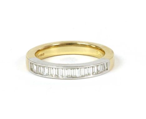 An 18ct gold diamond half eternity ring, by Fred E Ullmann, with a row of baguette cut diamonds, channel set to the white hea