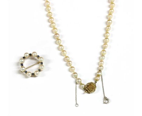 A 9ct gold cultured pearl and sapphire wreath brooch, with pin and roller catch, 27mm diameter, London, common control mark, 