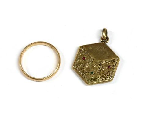 A gold hexagonal ruby and emerald set locket, with floral hand engraved decoration, marked 585, 19mm diameter, together with 