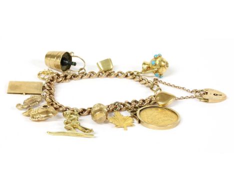 A gold charm bracelet, a 9ct gold curb link bracelet suspending twelve gold charms, to include a barrel, a fish with paste ey