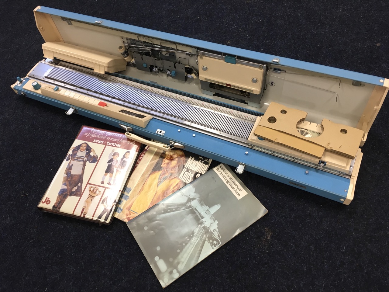 A Jones KH 588 knitting machine, complete with instruction manuals