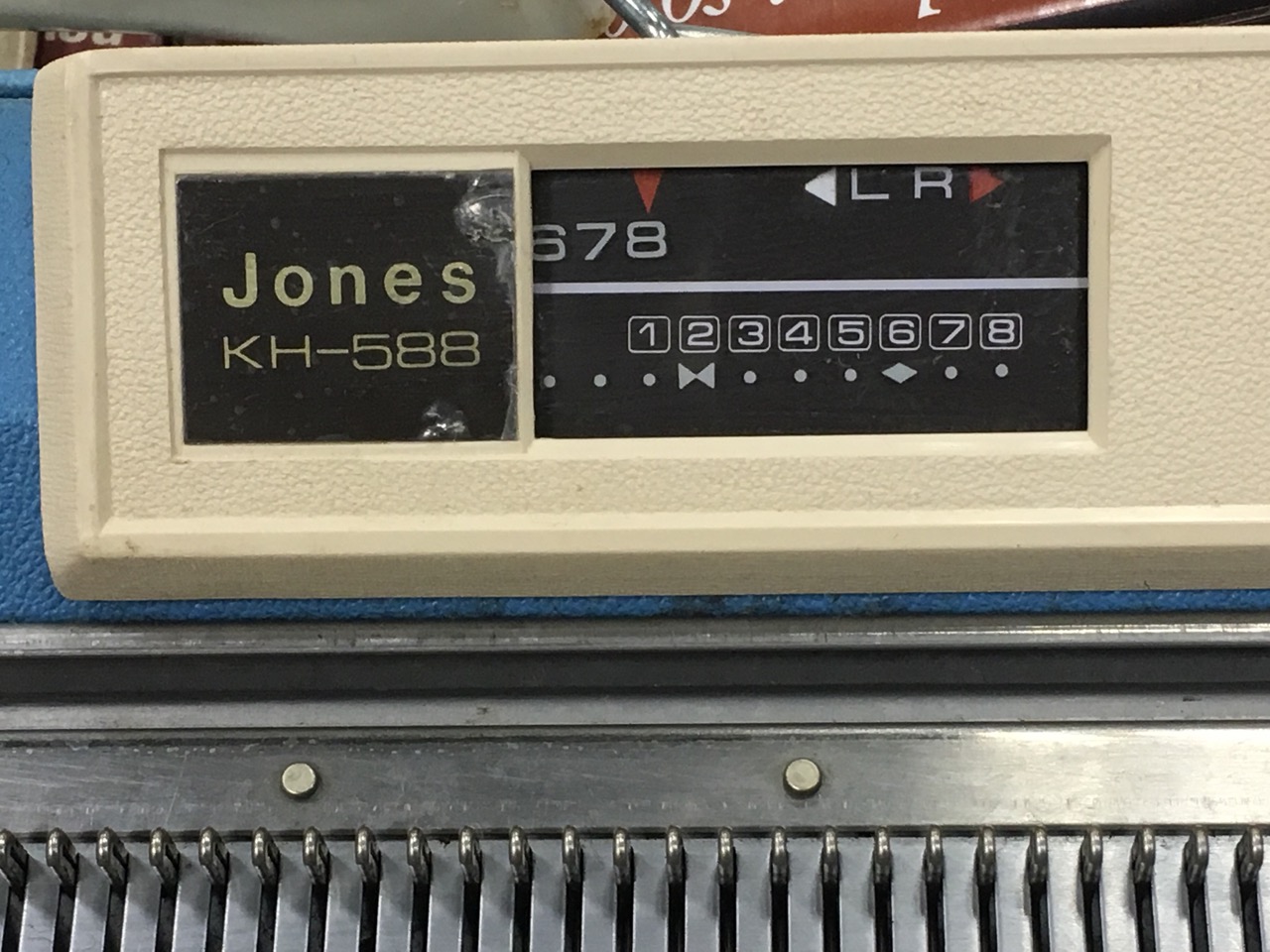 A Jones KH 588 knitting machine, complete with instruction manuals