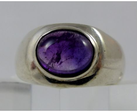 Sterling silver thick set ring set with cabouchon cut purple stone