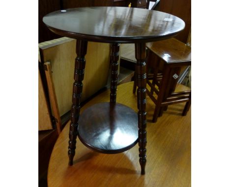 Circular walnut tripod table on turned supports