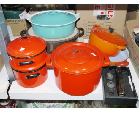 Le Creuset cast iron and turquoise enamel casserole, a Le Creuset cast iron and orange enamel casserole, a Le Creuset cast ir