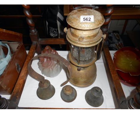3 brass bells, a Tilley lamp and a flame lamp shade