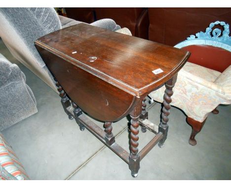 An oak barley twist gate leg table