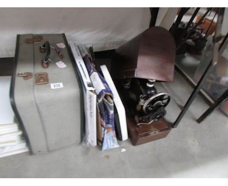 A case, bathroom scales & a sewing machine