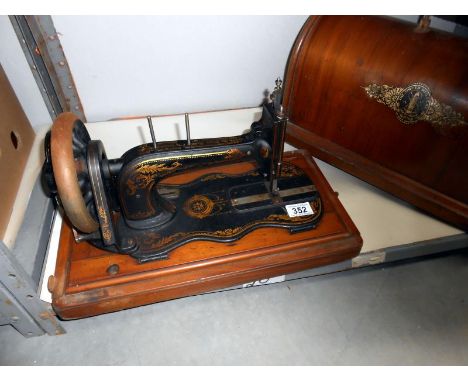 A cased vintage sewing machine
