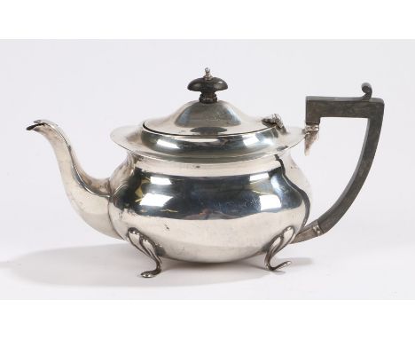 George V silver teapot, Birmingham 1911, maker John Henry Wynn, with angular ebony handle and oval finial, bulbous body, rais