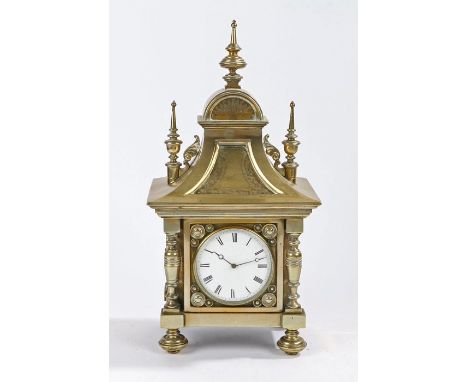 19th Century brass mantel clock, the case with shaped finials above an arched frieze and down swept lower section, the white 
