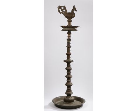 19th Century Indian brass floor standing temple lamp, with cockerel form finial above a dished lower section, shaped stem, on