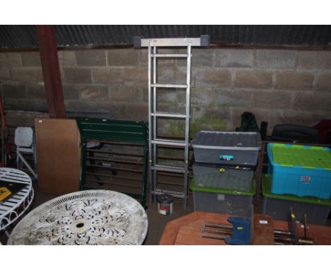 An extending aluminium ladder and a tin of paint