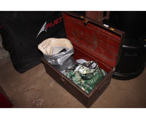 A metal trunk containing various horse tack etc