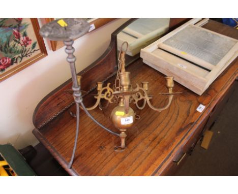 A candle holder together with a five branch brass chandelier 