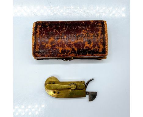 A brass and iron instrument for bloodletting. Manufacture marked on the reverse side. This item has its original box: 2.75"L 