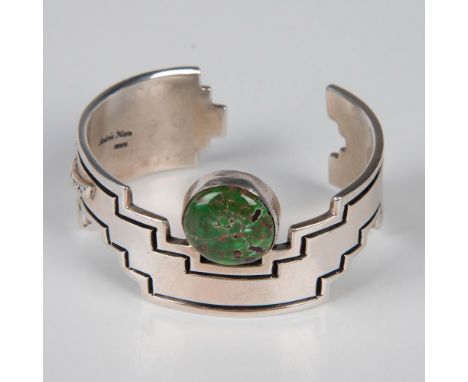 Unique and super stylized engraved tribal design sterling silver cuff with a raised lightning bolt arrow on one side. Round c