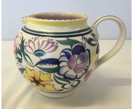 A medium sized Poole Pottery jug 11.5cm tall with rare circular mark