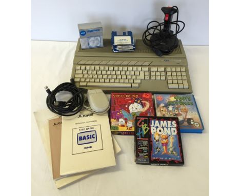 A vintage Atari 520ST home computer unit together with a Quickshot Python 1M joystick, mouse, video leads, a collection of fl