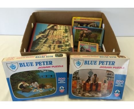 A box of vintage jigsaws to include Blue Peter.