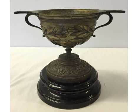 A heavy early 20th century/late 19th century brass chalice on ceramic box.