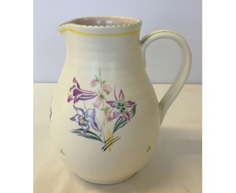 A tall Poole Pottery jug 20cm tall with rare circular mark