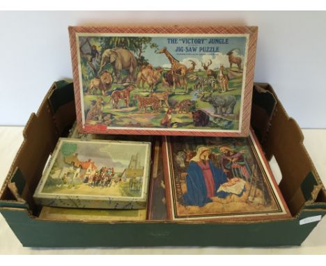 A box of vintage jigsaw puzzles including The 'Victory' Jungle puzzle (including 12 cut out standing animals).