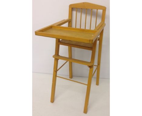 A light wood dolls high chair.