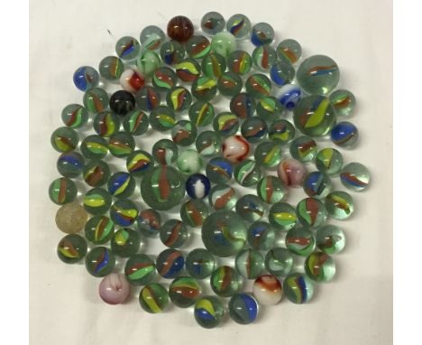 A tin of vintage glass marbles.