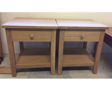 A pair of light wood bedside cabinets.