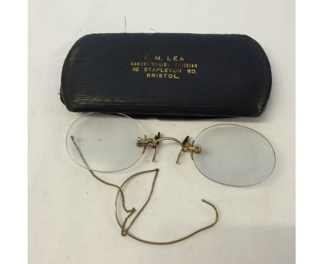 A cased pair of vintage spectacles with ear loop. Metal marked 12K G F.