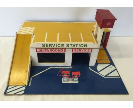 A wooden model Service Station with 2 model Esso pumps and working car lift. Made by Joytoy & Woodcrafts Malvern.