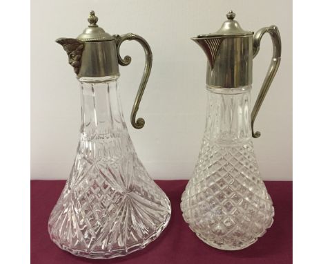 2 claret jugs with silver plated handles and tops.  One is cut crystal, ships decanter shape with a Satyrs head spout, and th