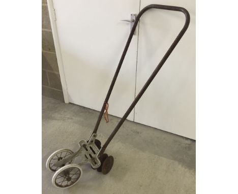 Vintage push hoe with 2 wheels.
