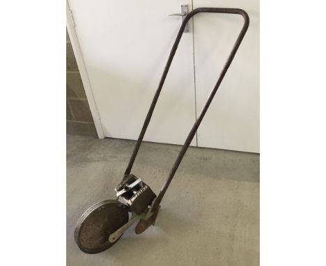 Vintage push hoe with 28lbs Imperial weight attached and 1 wheel.