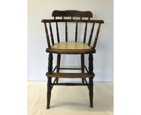 A vintage oak childs highchair.