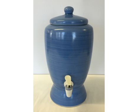 A blue ceramic water dispenser.