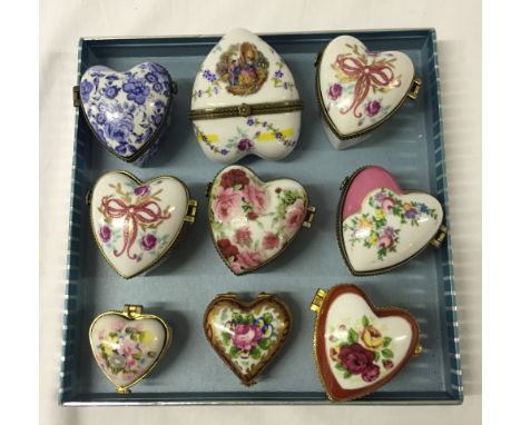 A collection of 9 heart shaped ceramic trinket boxes in different sizes and designs.