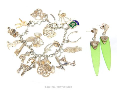 A chunky, sterling silver, vintage, charm bracelet set with seventeen assorted sterling silver charms (Weight: 46.2 g) with a