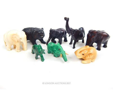 A collection of elephant figures including an early 20th century carved ivory figure of an elephant (damaged trunk and missin