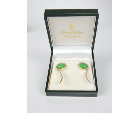 A pair of silver-gilt, jade and diamond earrings, each earring composed of a central, bezel-set, oval-shaped green jade caboc