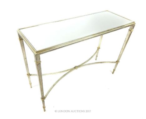 A silvered metal console table of rectangular form, having a mirrored top, the supports joined by curved stretchers, 75 x 110