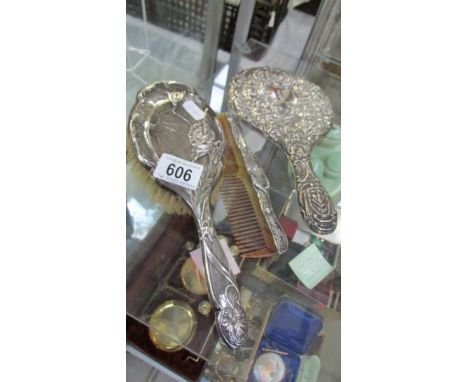 A silver backed mirror, brush and comb.