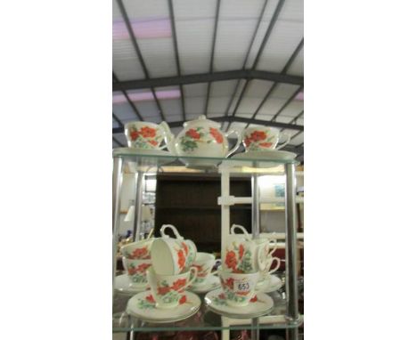 23 pieces of Duchess 'Poppies' teaware, 11 tea cups, 11 saucers and a teapot. 