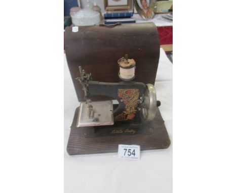 A cased 'Little Betty' vintage child's sewing machine.